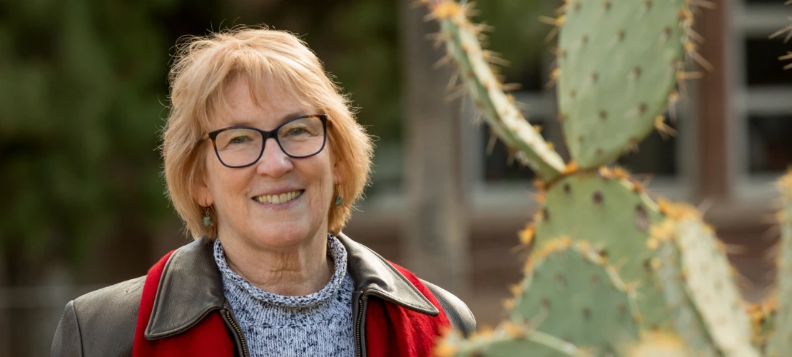 Photo of Dr. Brown shown smiling near the Cactus Garden