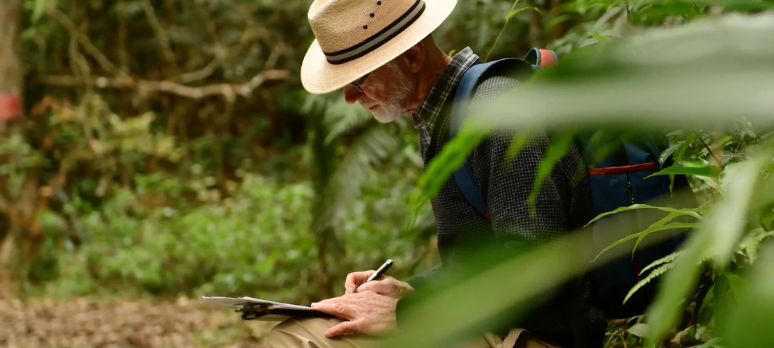 Peter Chesson is seen writing notes while in conducting research in the jungle
