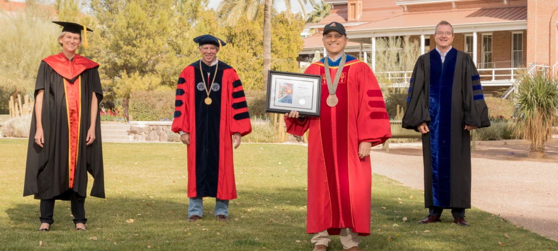 Ricardo Valerdi is seen posing with university leadership in front of Old Main