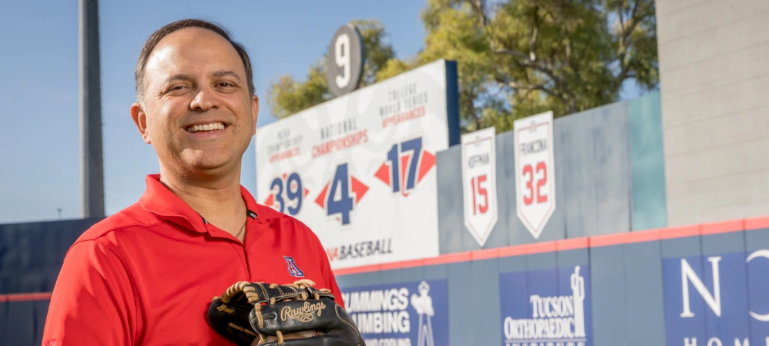 Ricardo Valerdi is seen in front of the number 9 at a baseball stadium