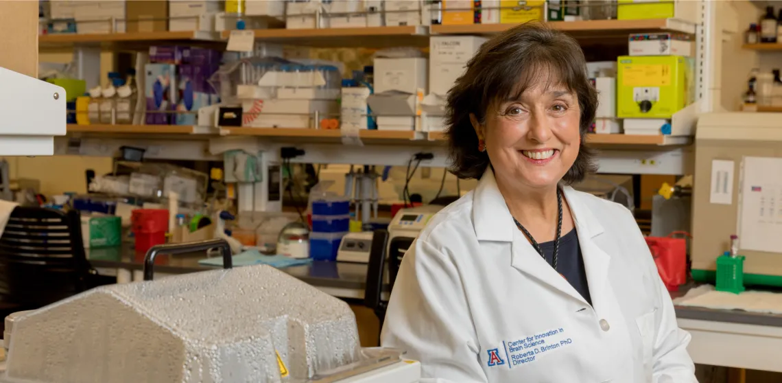 Dr. Brinton smiling facing the camera while in her lab