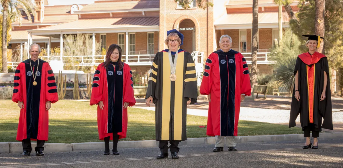 Dr. Brown posing with university leadership in front of Old Main