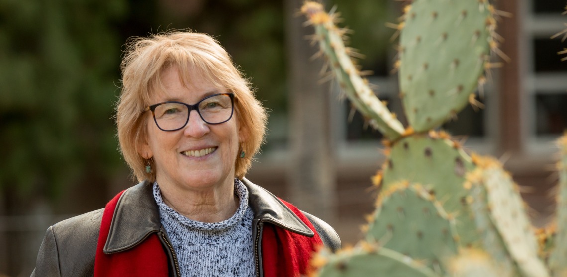 Photo of Dr. Brown shown smiling near the Cactus Garden
