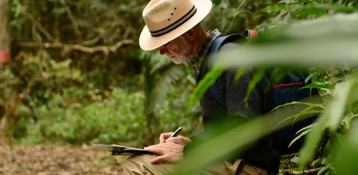 Peter Chesson is seen writing notes while in conducting research in the jungle