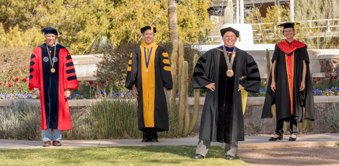 Jeff Stone is seen posing with university leadership in front of Old Main