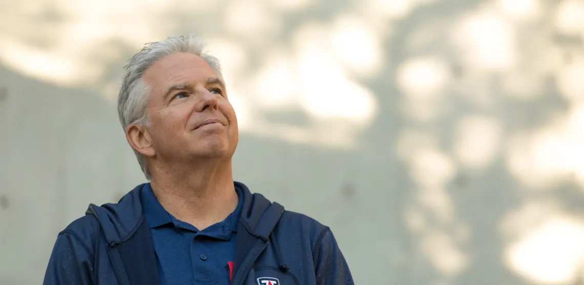 Jeff Stone poses near the steps of the Integrated Learning Center on campus