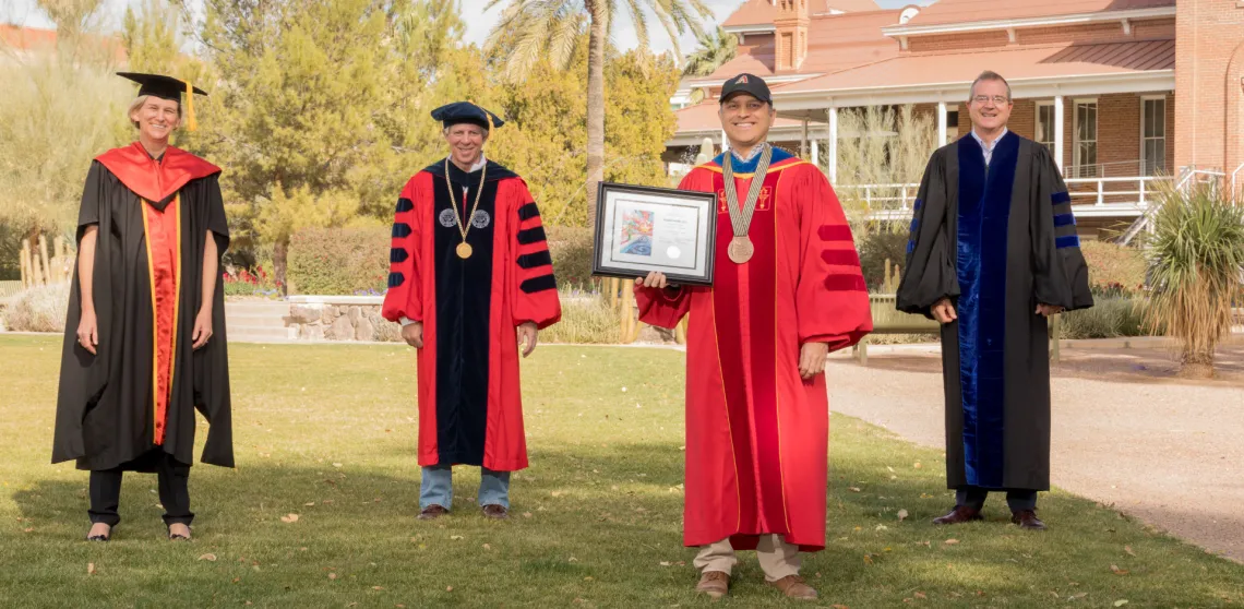 Ricardo Valerdi is seen posing with university leadership in front of Old Main