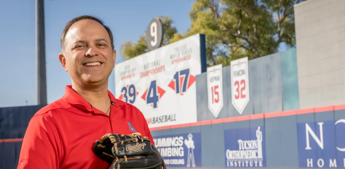 Ricardo Valerdi is seen in front of the number 9 at a baseball stadium